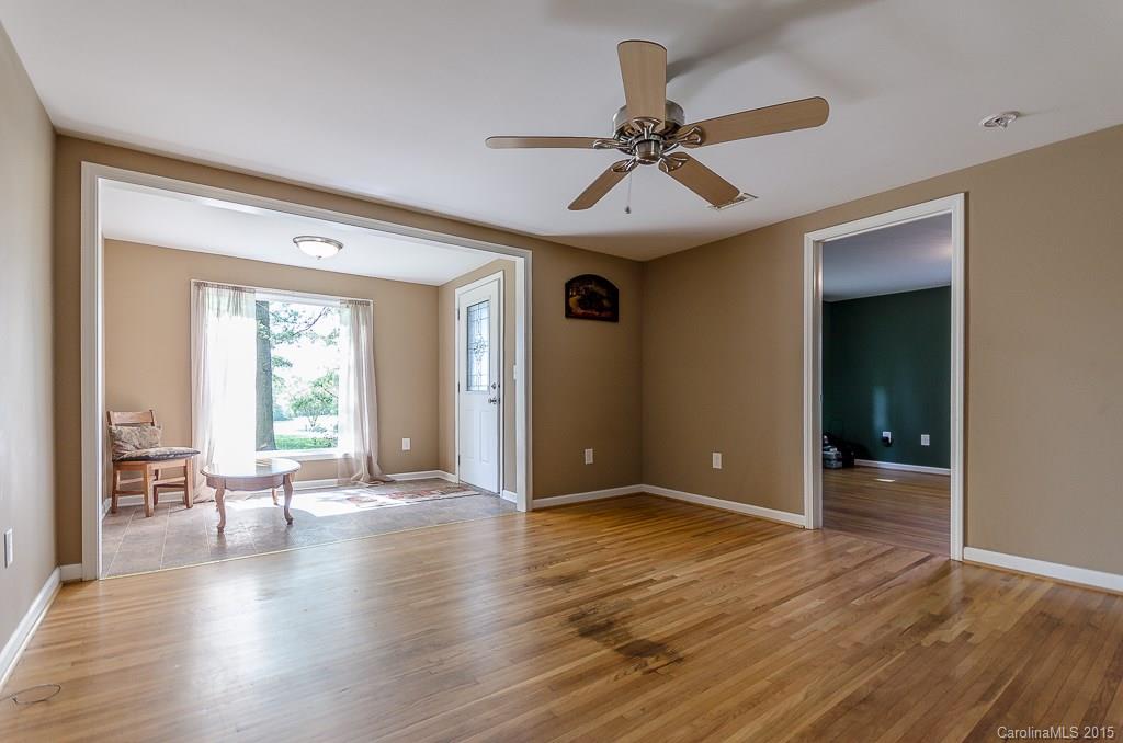 4401 Austin Road Monroe, NC 28112 - Photo 4 of 22 a view of an empty room with wooden floor and a window
