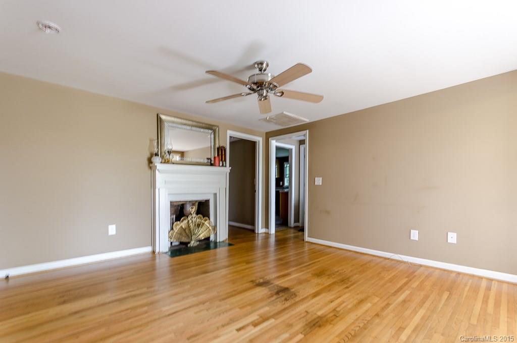 4401 Austin Road Monroe, NC 28112 - Photo 5 of 22 a view of a livingroom with wooden floor a ceiling fan and staircase