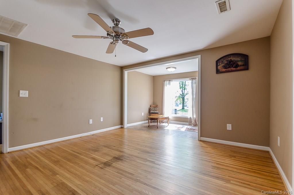 4401 Austin Road Monroe, NC 28112 - Photo 6 of 22 a view of an empty room with wooden floor and a ceiling fan