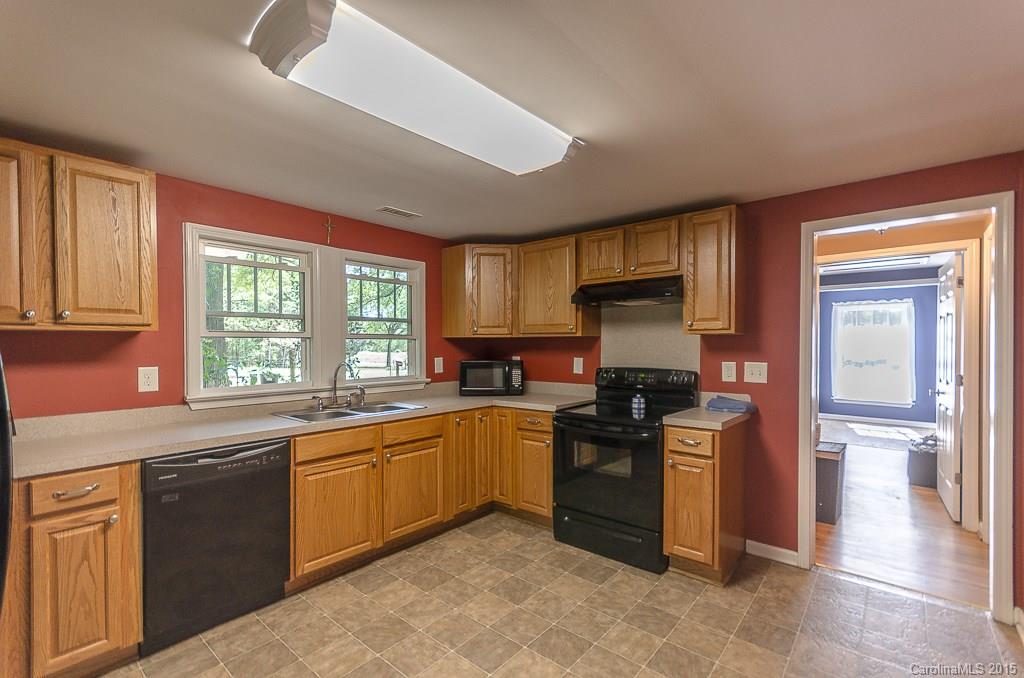 4401 Austin Road Monroe, NC 28112 - Photo 8 of 22 a kitchen with stainless steel appliances granite countertop a stove sink and cabinets