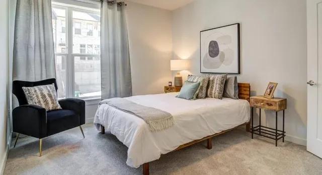 a bedroom with a bed and a couch