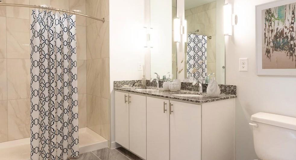 750 Avondale Creek Dr., Unit 206 Decatur, GA 30032 - Photo 26 of 35 a bathroom with a granite countertop sink and a toilet