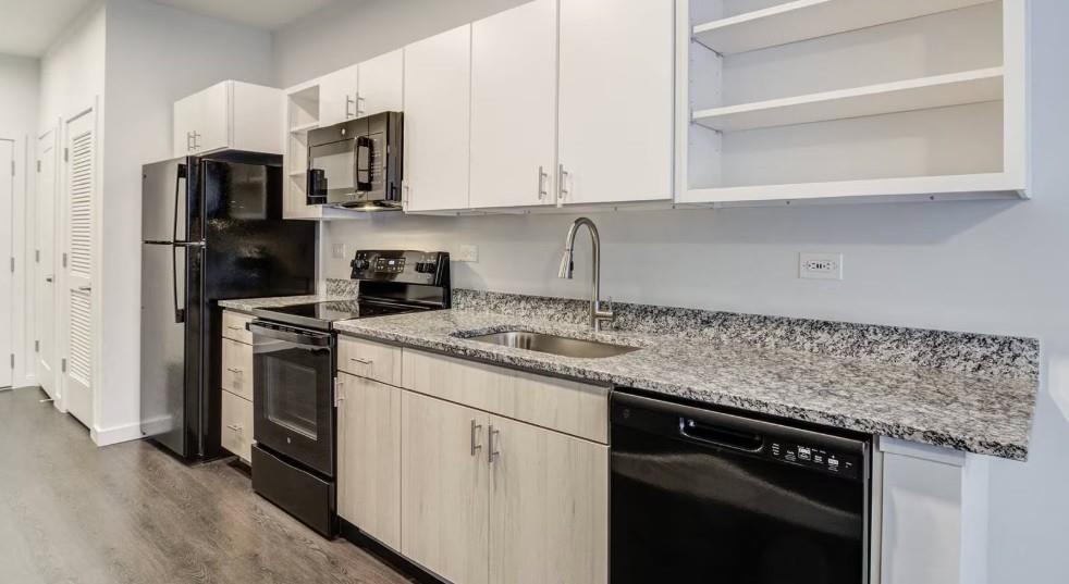750 Avondale Creek Dr., Unit 206 Decatur, GA 30032 - Photo 3 of 35 a kitchen with stainless steel appliances granite countertop white cabinets and a stove