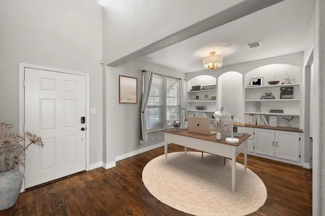 a living room with hard wood floors and a window