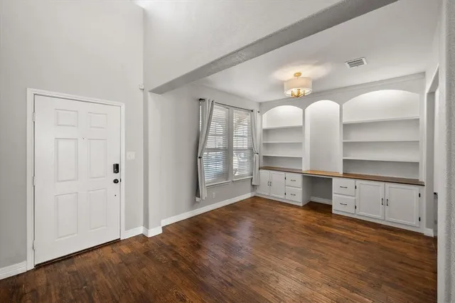 a room with cabinets and wooden floor