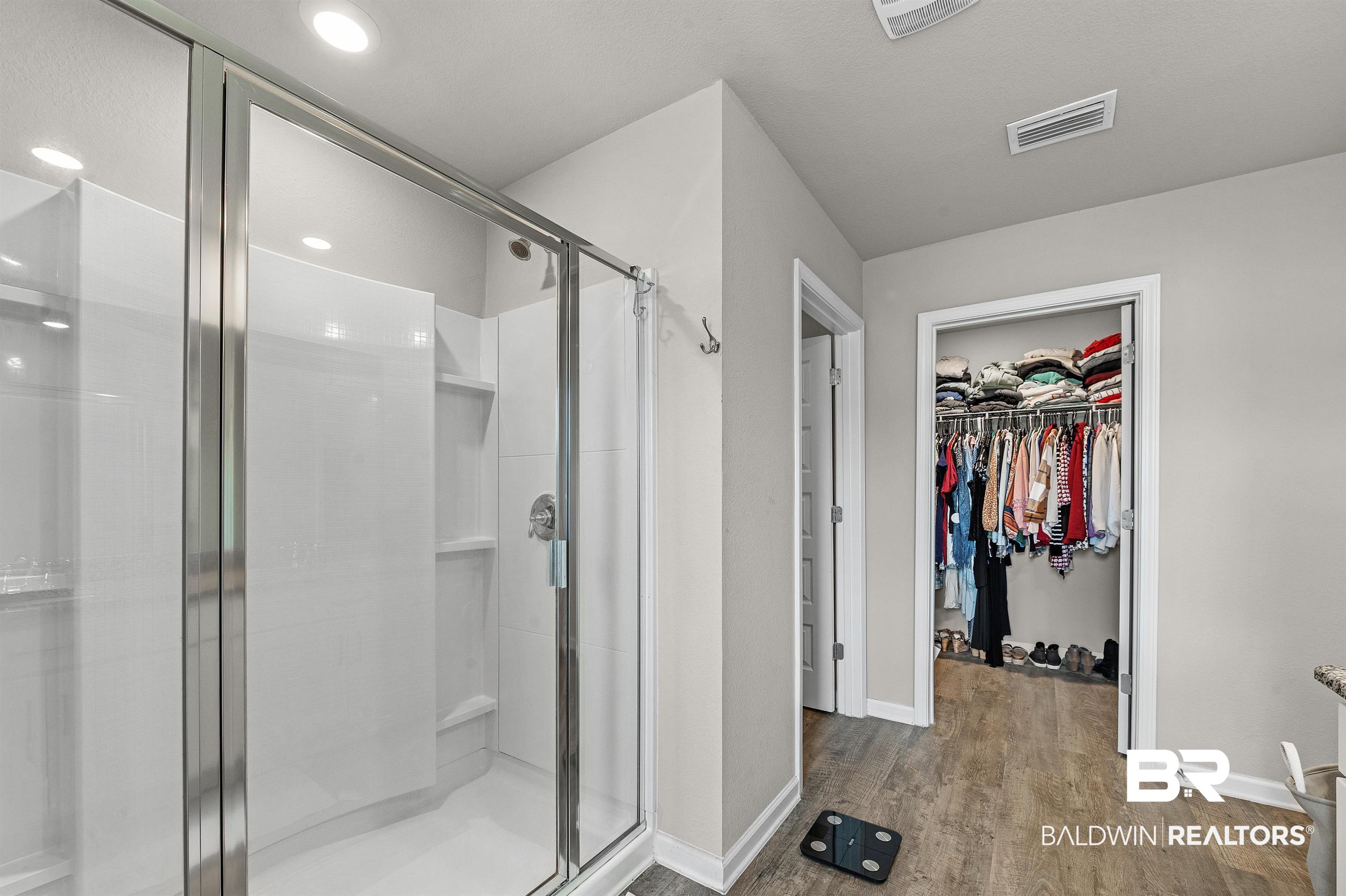 24549 Broken Sound Loop Orange Beach, AL 36561 - Photo 33 of 57 Bathroom featuring hardwood / wood-style flooring and walk in shower