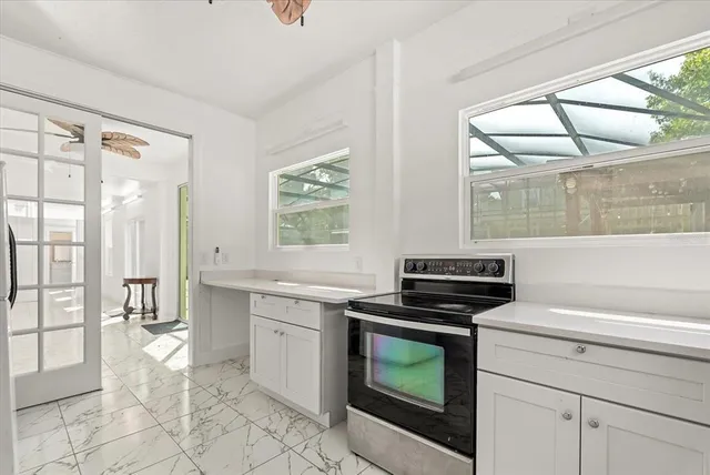 a swimming pool with a lawn chairs and potted plants