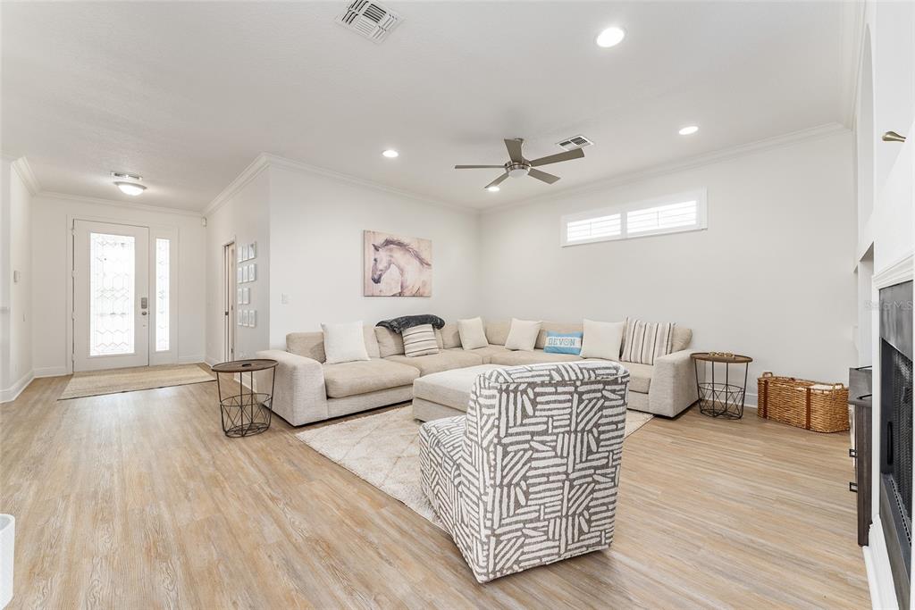 4987 Southwest 63rd Loop Ocala, FL 34474 - Photo 13 of 56 a living room with furniture and a wooden floor
