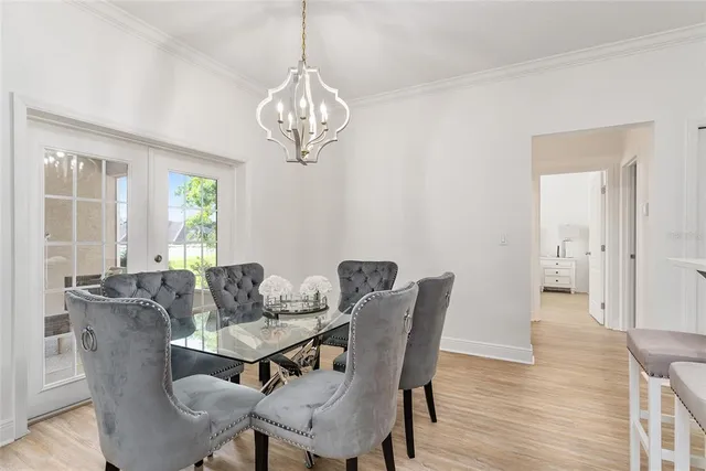 a view of a dining room with furniture wooden floor and chandelier