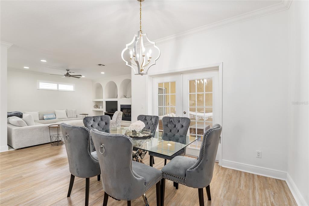 4987 Southwest 63rd Loop Ocala, FL 34474 - Photo 16 of 56 a view of a dining room with furniture wooden floor and chandelier