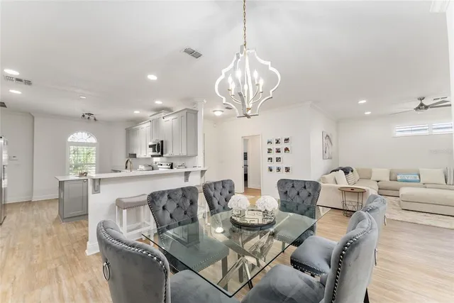 a large white kitchen with stainless steel appliances
