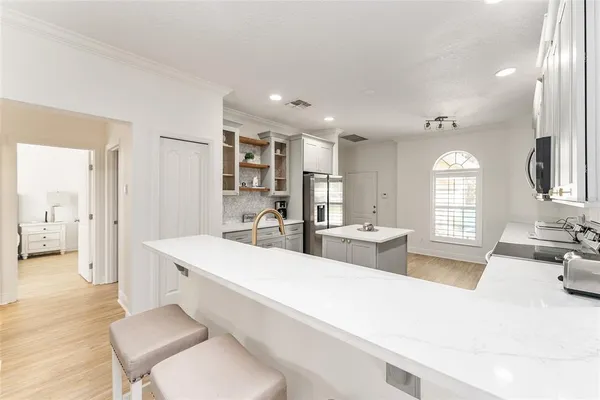 a kitchen with a stove a sink and a refrigerator