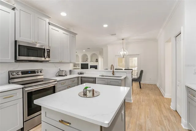 a kitchen with stainless steel appliances wooden cabinets and entryway
