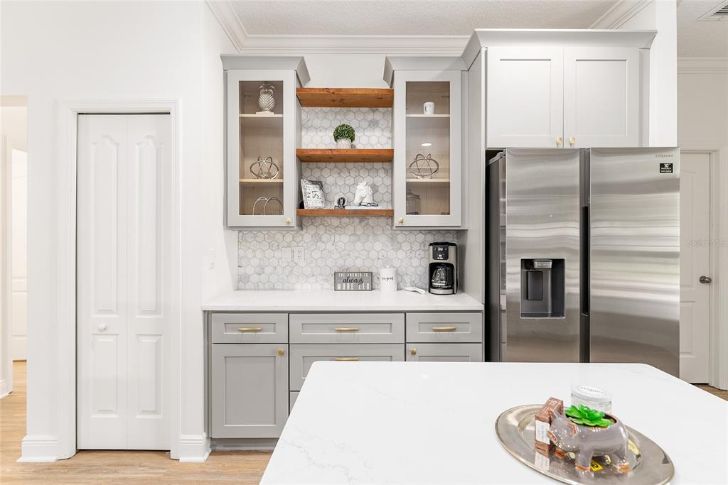 4987 Southwest 63rd Loop Ocala, FL 34474 - Photo 24 of 56 a kitchen with stainless steel appliances wooden cabinets and entryway
