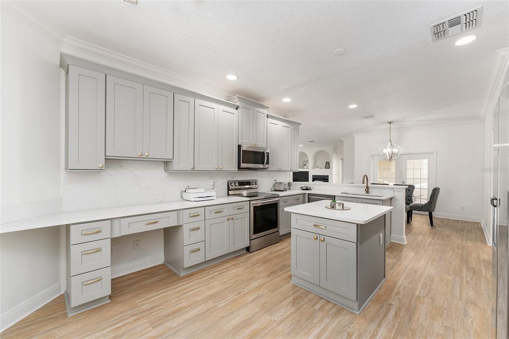 4987 Southwest 63rd Loop Ocala, FL 34474 - Photo 26 of 56 a kitchen with a sink cabinets and wooden floor