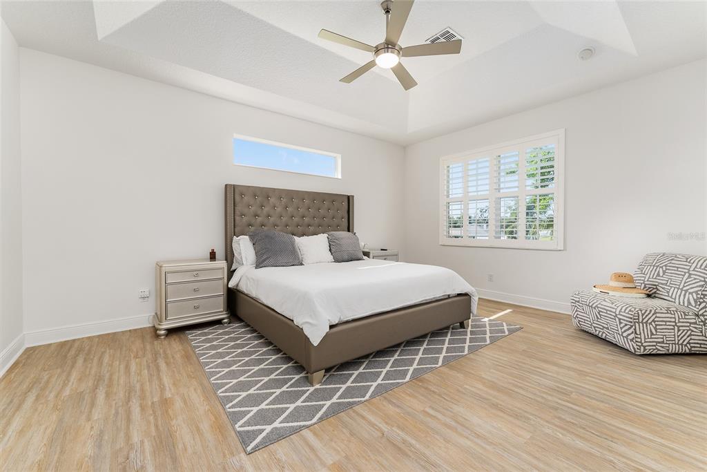 4987 Southwest 63rd Loop Ocala, FL 34474 - Photo 30 of 56 a bedroom with a bed and wooden floor