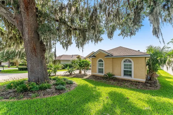 a front view of house with yard and green space