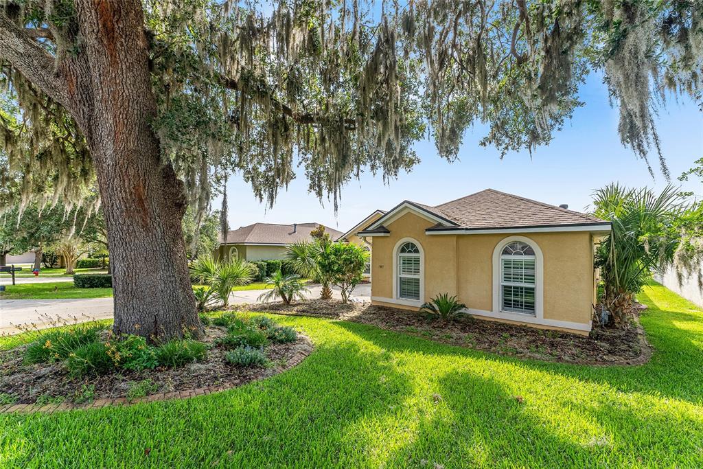 4987 Southwest 63rd Loop Ocala, FL 34474 - Photo 3 of 56 a front view of house with yard and green space