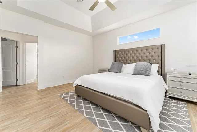 a spacious bathroom with a tub sink and mirror