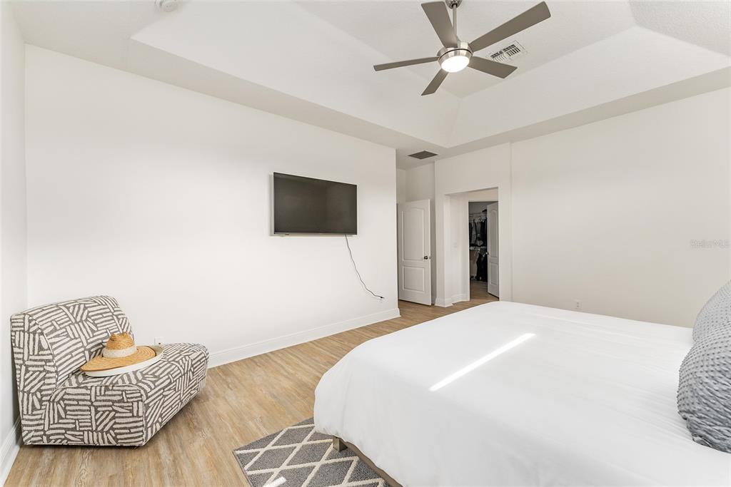 4987 Southwest 63rd Loop Ocala, FL 34474 - Photo 32 of 56 a bedroom with a bed and a television