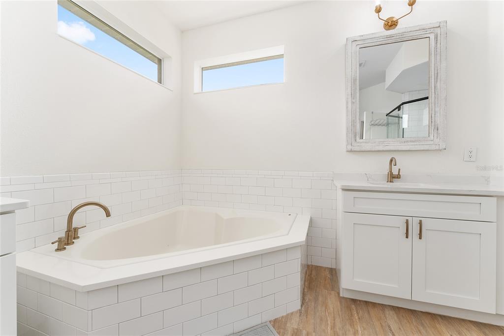 4987 Southwest 63rd Loop Ocala, FL 34474 - Photo 37 of 56 a bathroom with a sink and a bathtub