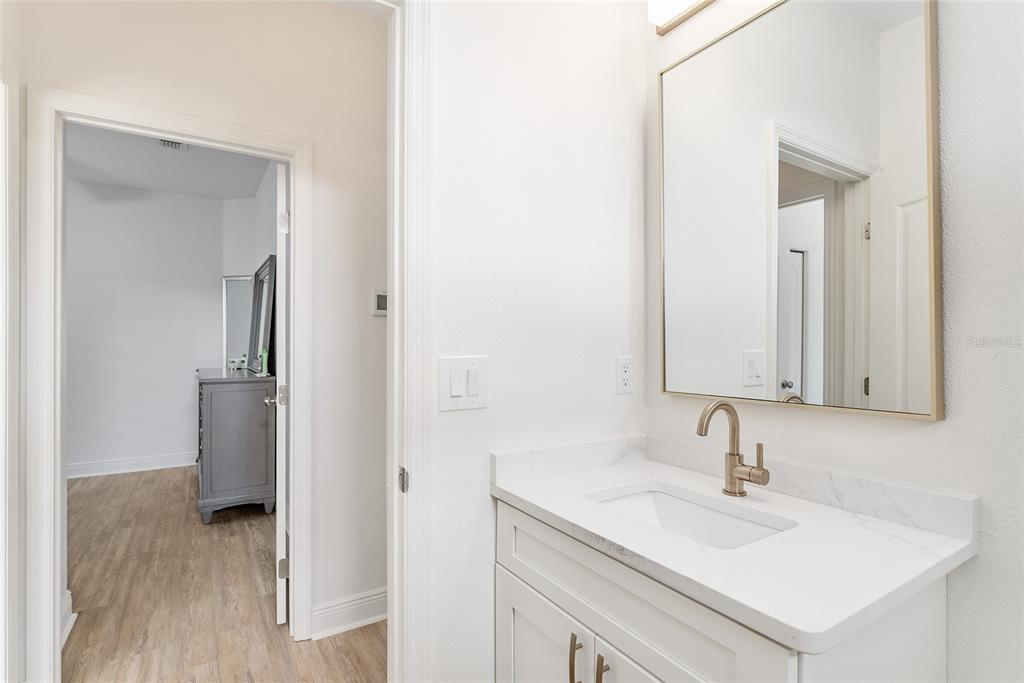 4987 Southwest 63rd Loop Ocala, FL 34474 - Photo 44 of 56 a bathroom with a sink and a mirror