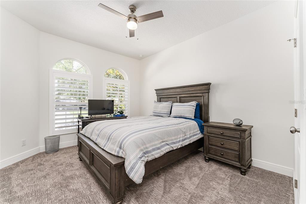 4987 Southwest 63rd Loop Ocala, FL 34474 - Photo 45 of 56 a bedroom with a bed dresser and a window