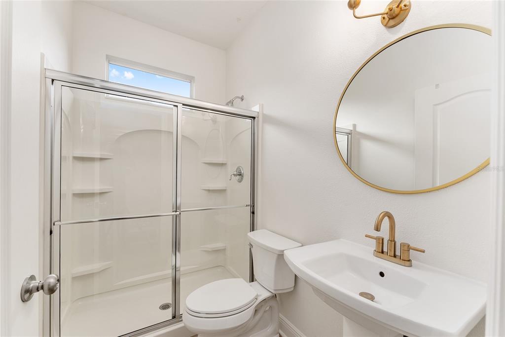 4987 Southwest 63rd Loop Ocala, FL 34474 - Photo 47 of 56 a bathroom with a toilet a sink and a mirror