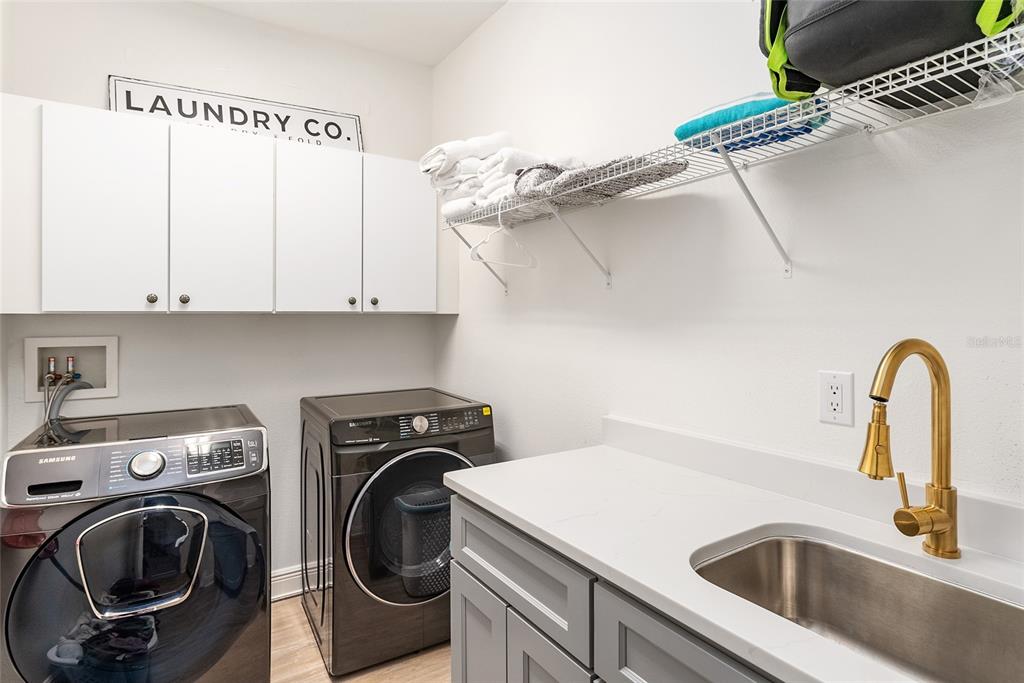 4987 Southwest 63rd Loop Ocala, FL 34474 - Photo 48 of 56 a utility room with sink dryer and washer