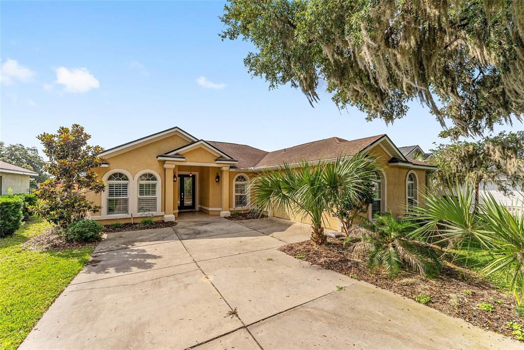 4987 Southwest 63rd Loop Ocala, FL 34474 - Photo 5 of 56 a view of a house with a yard