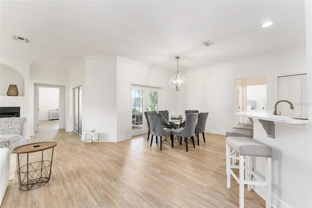 a living room with furniture a fireplace and a table