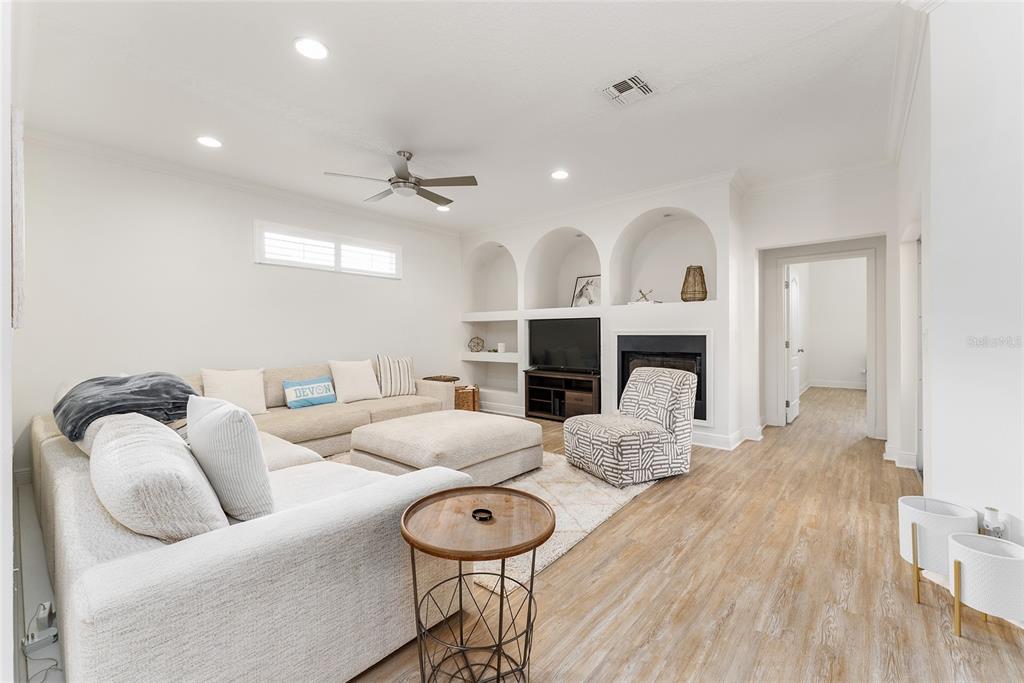 4987 Southwest 63rd Loop Ocala, FL 34474 - Photo 10 of 56 a living room with furniture a fireplace and a table