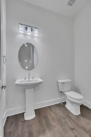 a bathroom with a sink toilet and a mirror