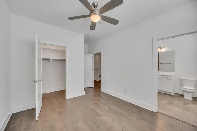 a view of a room with a ceiling fan and a bathroom