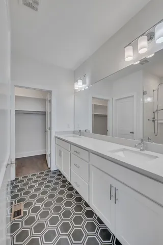 a spacious bathroom with a sink and a mirror
