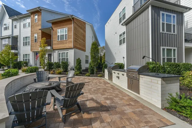 a view of a house with backyard and sitting area