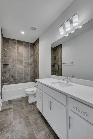 a bathroom with a sink a toilet and bathtub