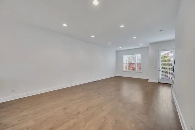 an empty room with windows and closet