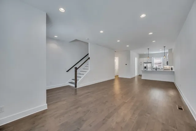 a view of a kitchen with a sink and wooden floor
