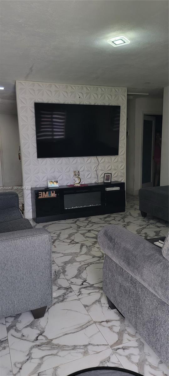 301 Southwest 36th Avenue Miami, FL 33135 - Photo 6 of 32 a living room with a flat screen tv and kitchen view
