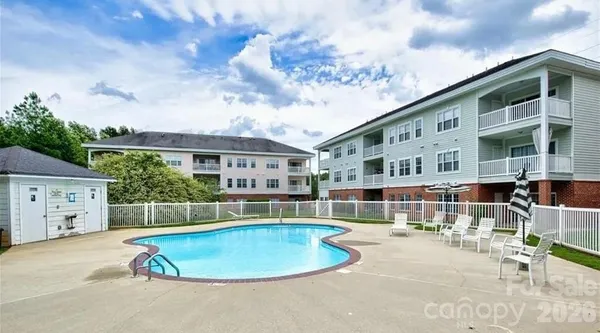 swimming pool view with plants and trees
