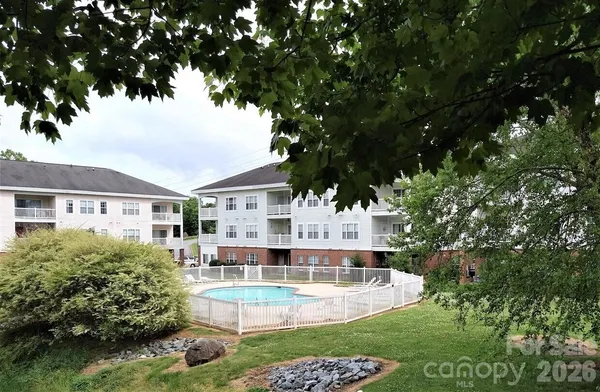 a view of a house with swimming pool and sitting area