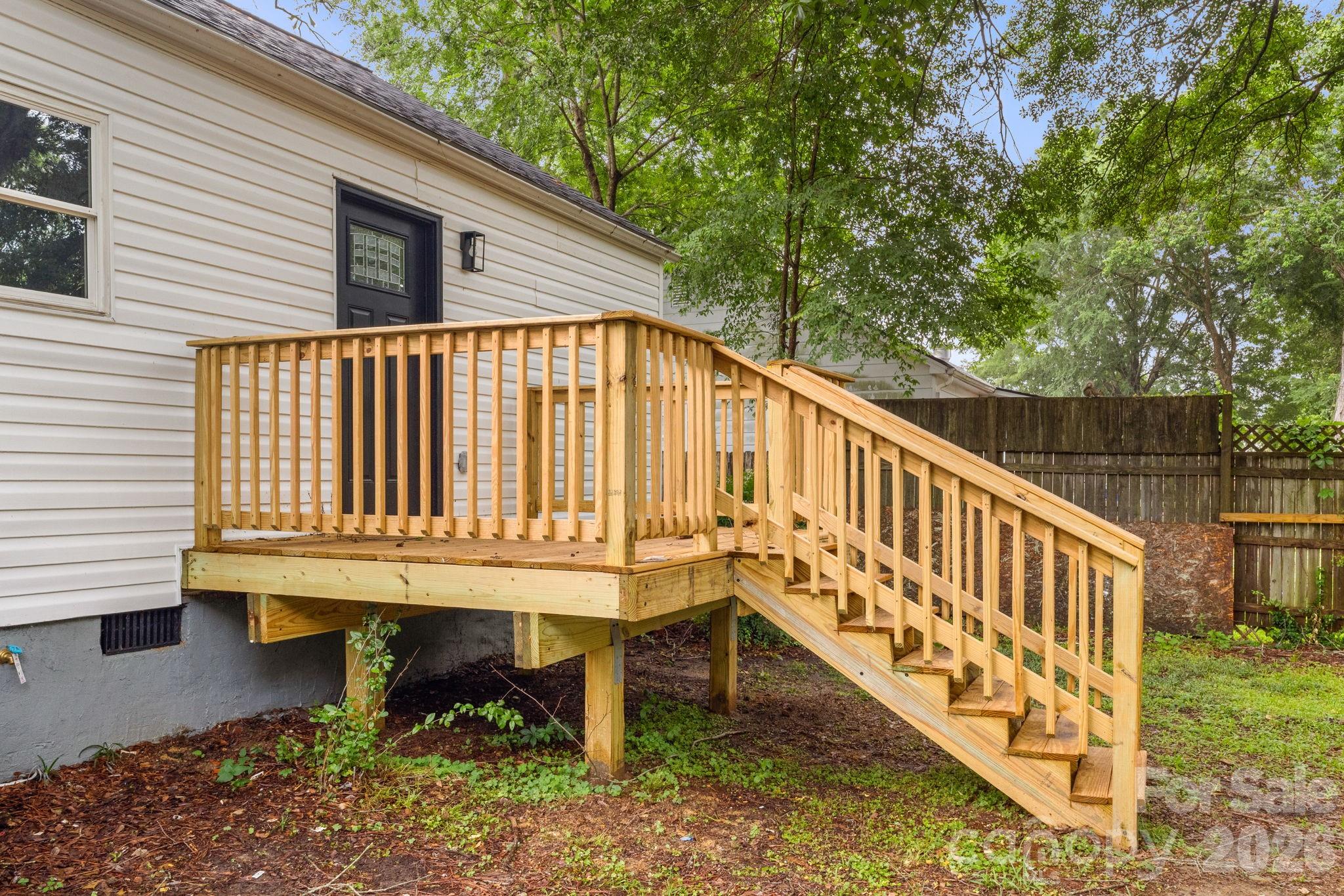 110 Courtland Street Chester, SC 29706 - Photo 21 of 22 a blue bench sitting in front of a house