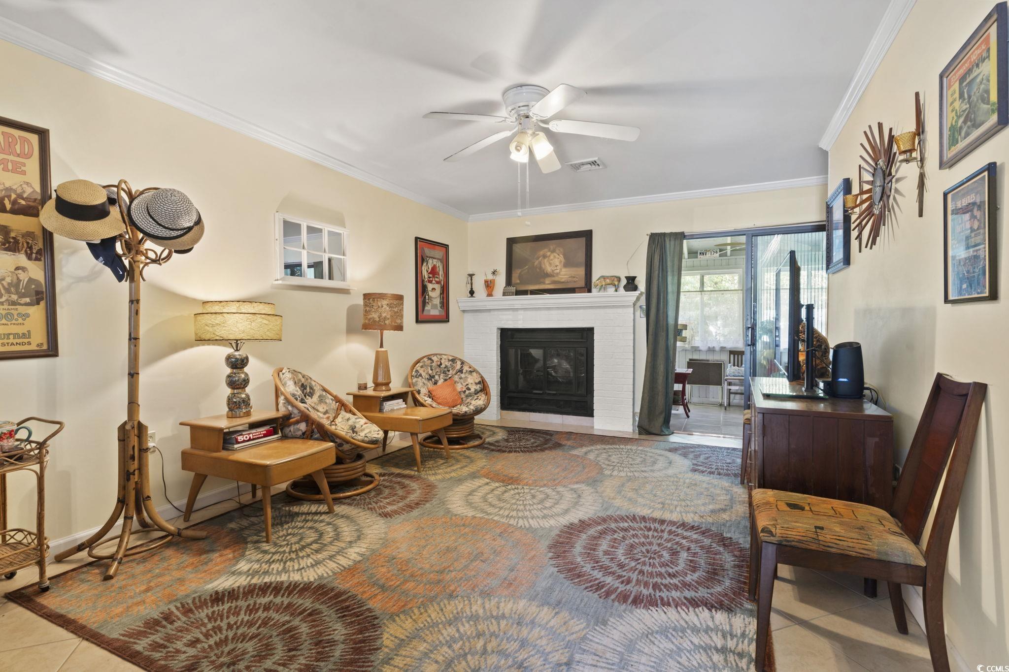 55 Beaver Pond Loop, Unit 15 Pawleys Island, SC 29585 - Photo 12 of 24 Sitting room with light tile patterned floors, crown molding, a brick fireplace, and ceiling fan
