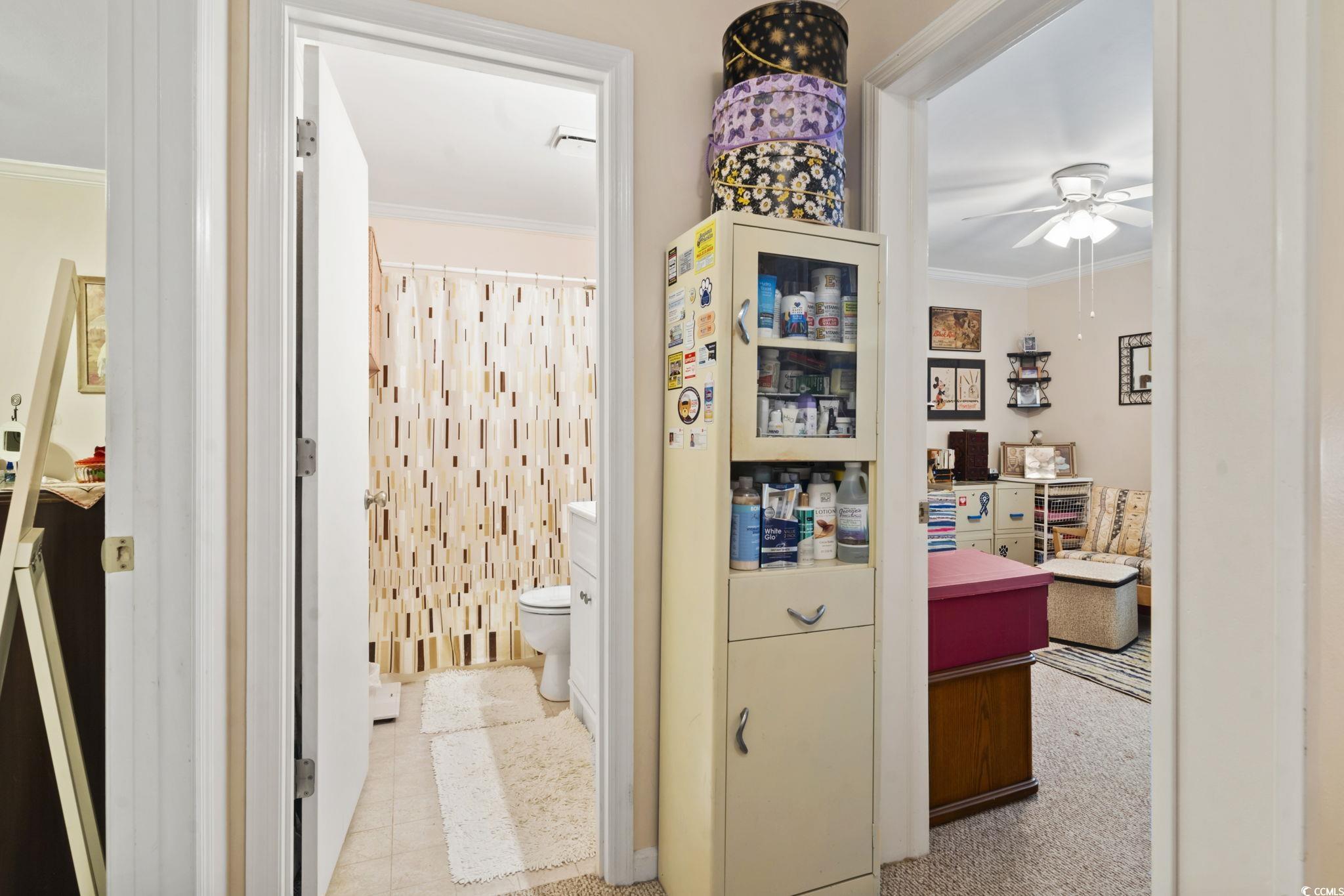 55 Beaver Pond Loop, Unit 15 Pawleys Island, SC 29585 - Photo 10 of 24 Bathroom featuring crown molding, curtained shower, and a ceiling fan