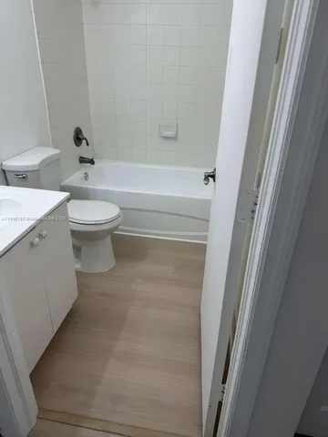 a bathroom with a sink toilet and mirror