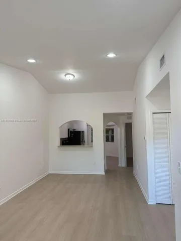 a kitchen with a sink a counter top space and stainless steel appliances