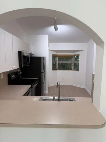 a kitchen with a refrigerator sink and microwave