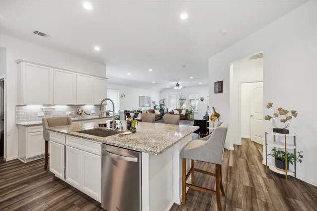 a view of a house with a yard and sitting area
