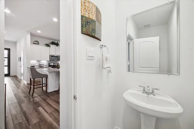 a bathroom with a tub sink and mirror